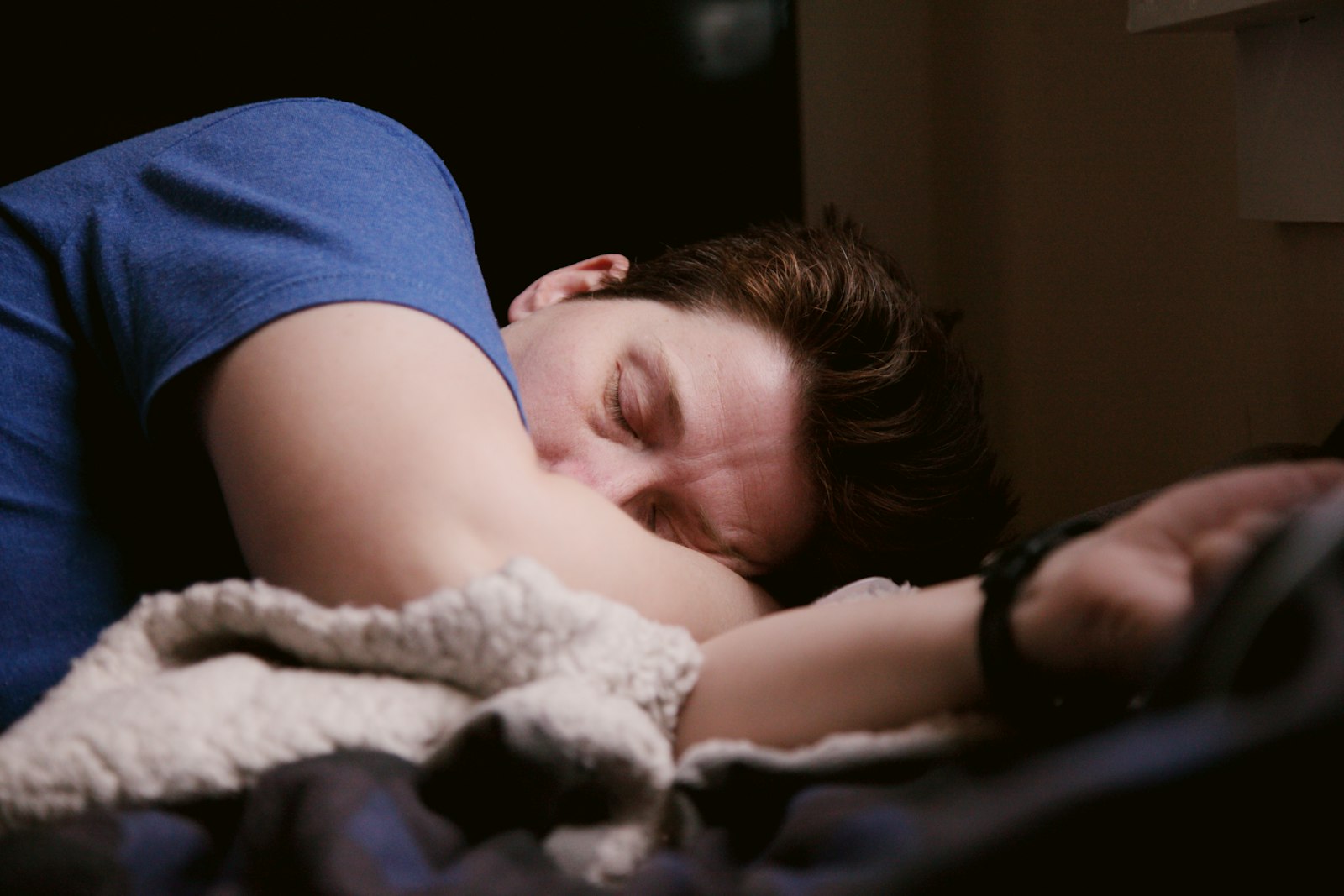A man sleeping well in a dark bedroom
